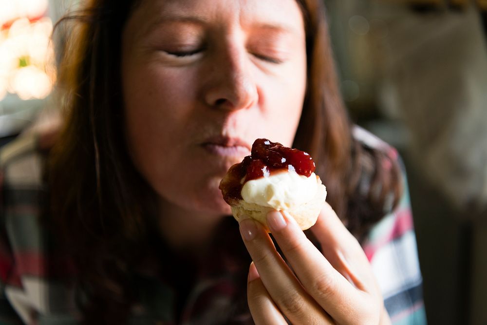 Woman enjoying a bite of a sweet pastry
