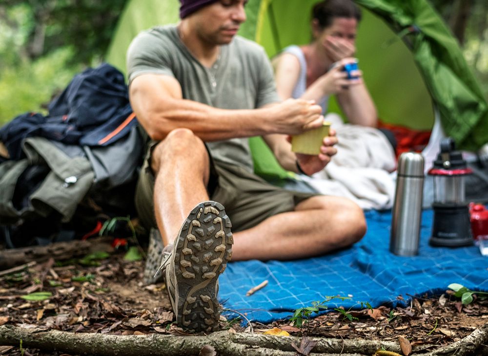 Group of diverse friends camping in the forest