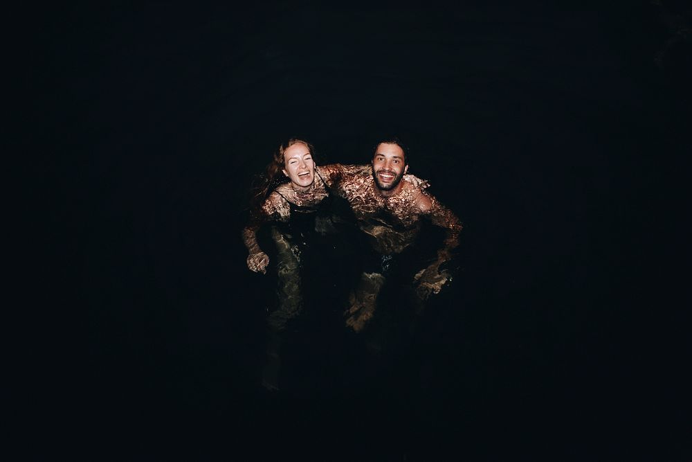 Couple playing in the dark water