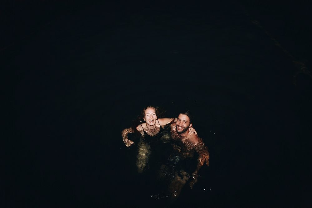 Couple playing in the dark water