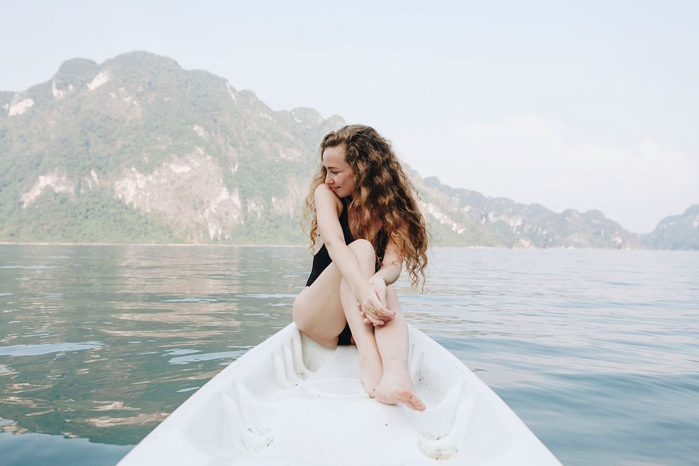 Woman relaxing on a canoe at a lake