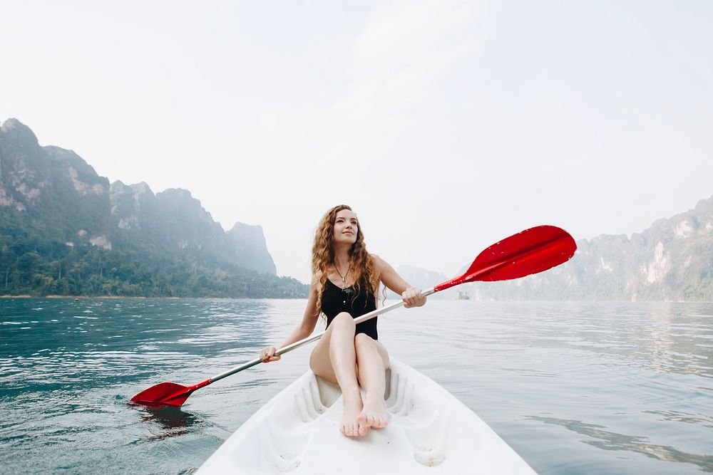 Woman paddling a canoe through a national park