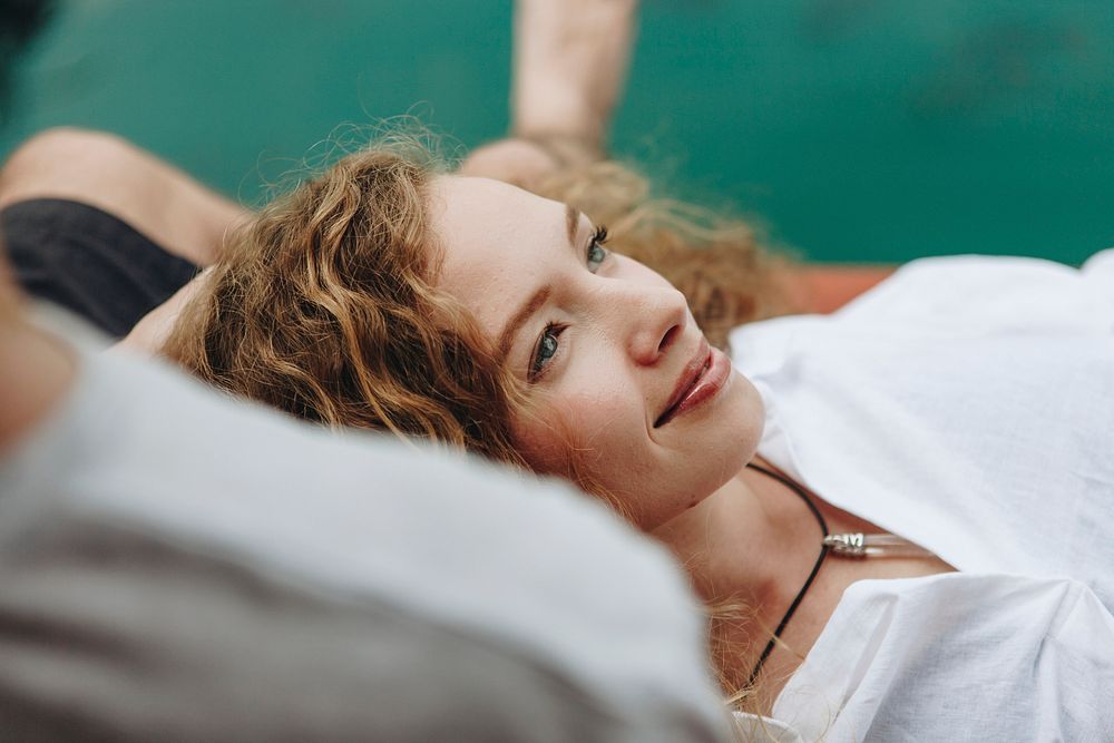 Woman relaxing in her boyfriends lap