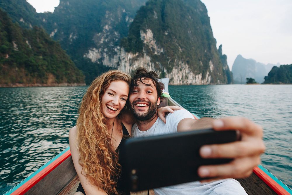 Couple taking selfie on a longtail boat