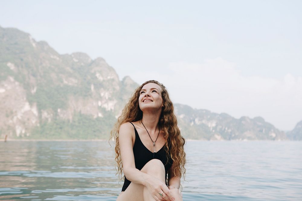 Happy woman by a lake