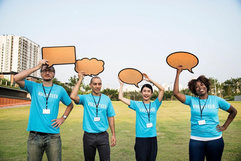 Group of happy and diverse volunteers with speech bubbles