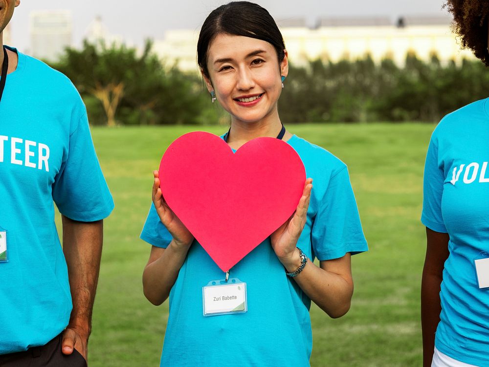 Happy Japanese volunteer with a heart