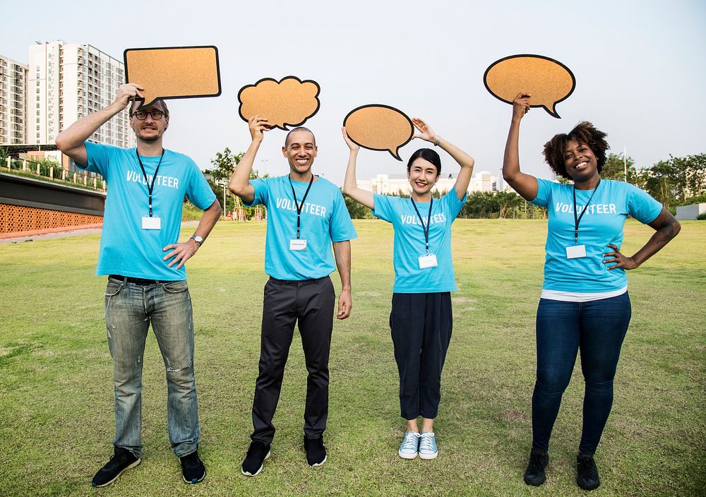 Group of happy and diverse volunteers with speech bubbles