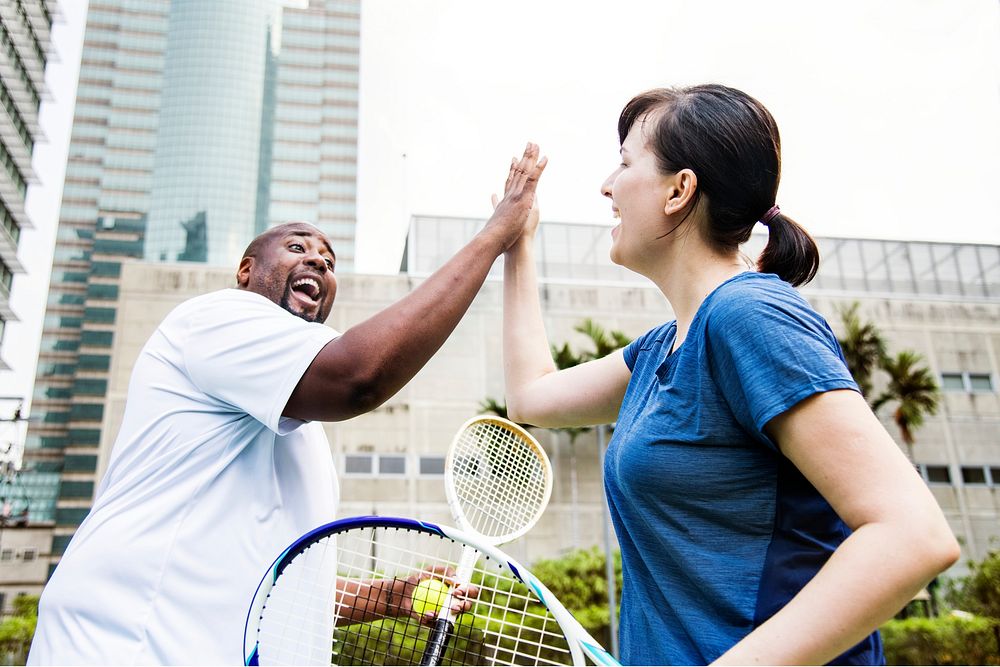 Couple playing tennis as a team