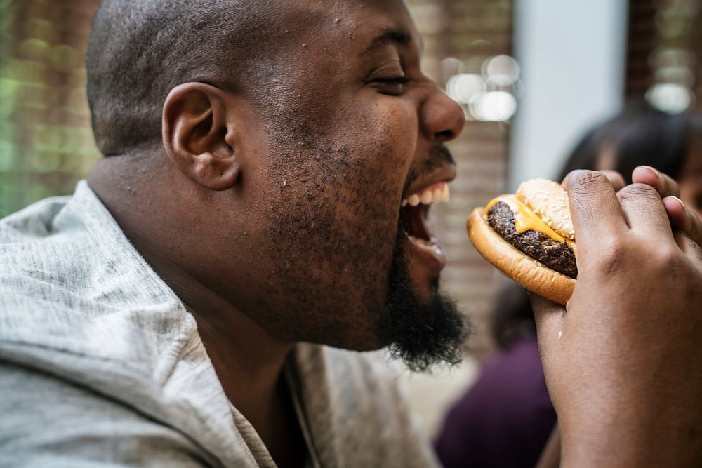 Man eating a big hamburger