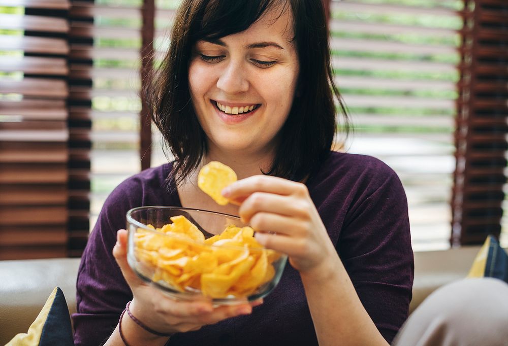 Woman enjoying a bowl of chips