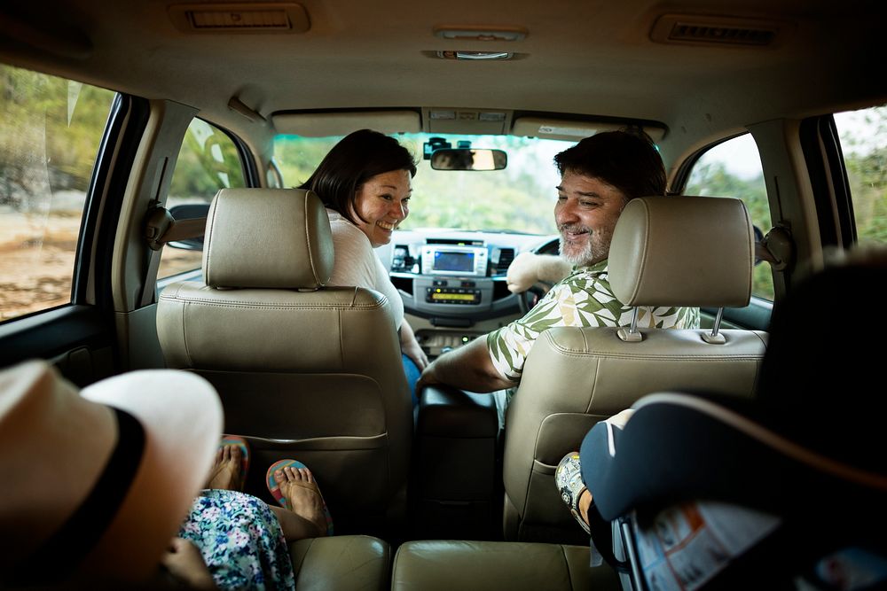Cheerful family in the car on a road trip