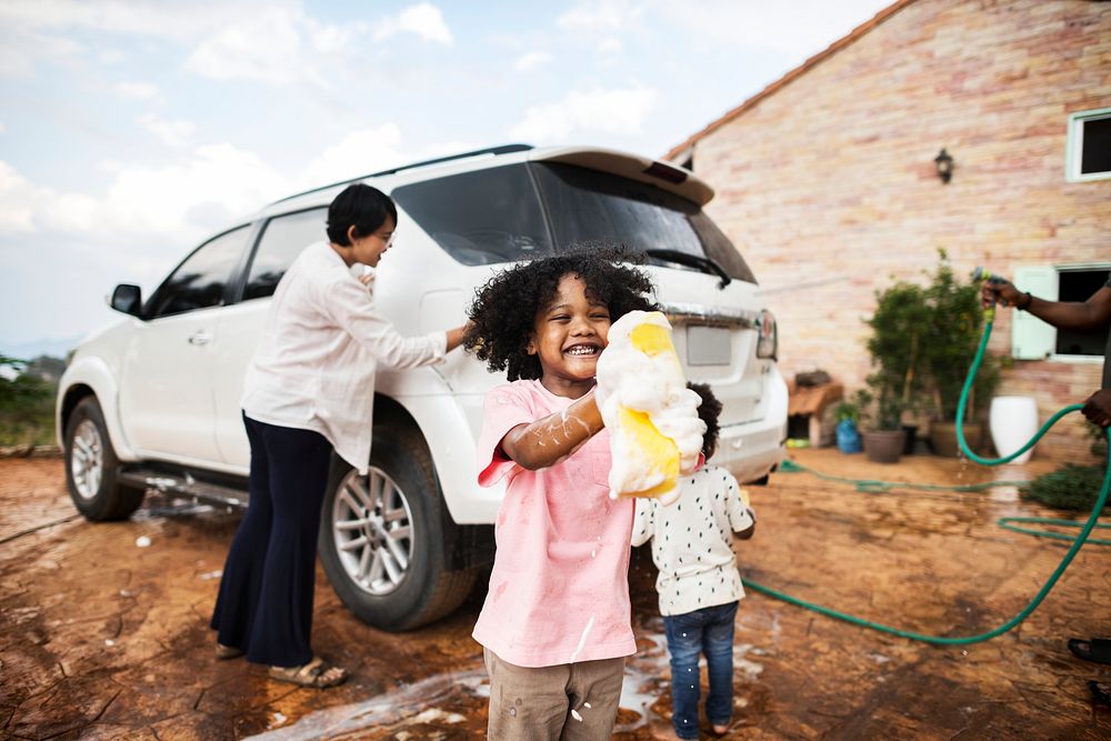 Family washing their white car