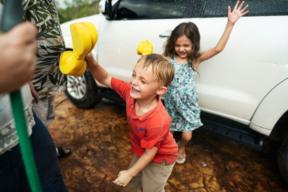 Kids helping to wash a car