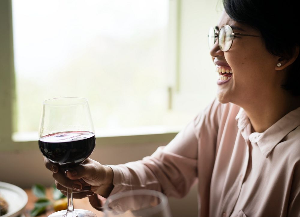 Cheerful woman enjoying a glass of wine