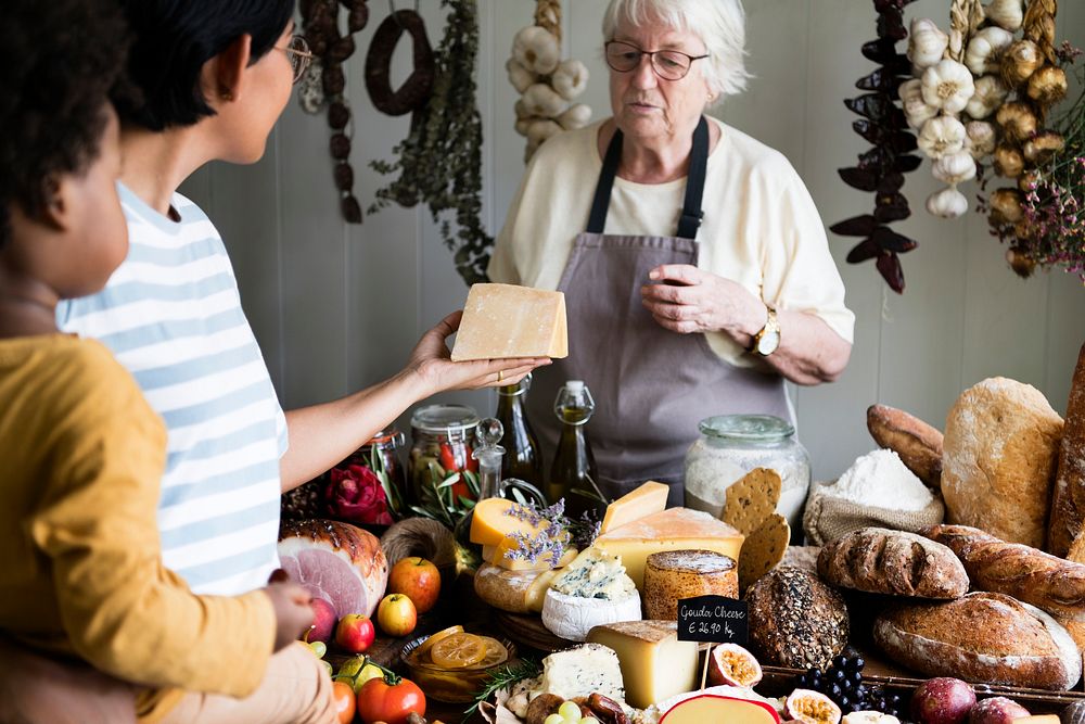 Elderly woman selling cheese at a farm shop