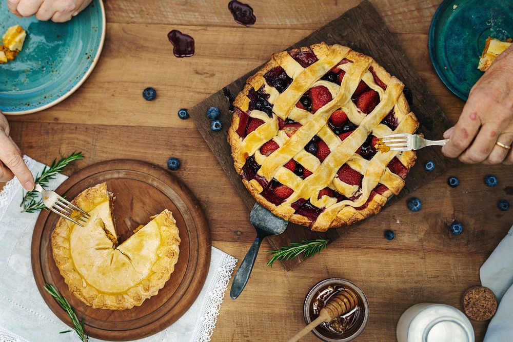 People eating fruit and mixed berries pie