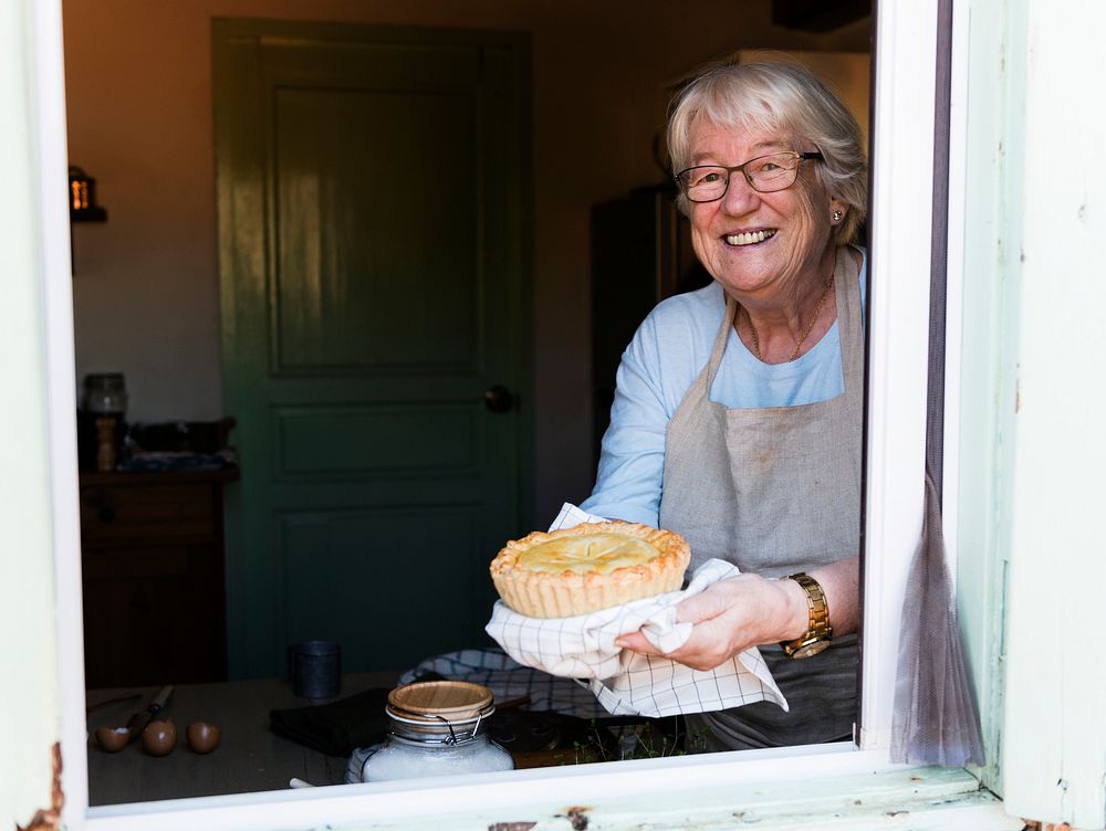 Grandmother holding a freshly baked pumpkin pie