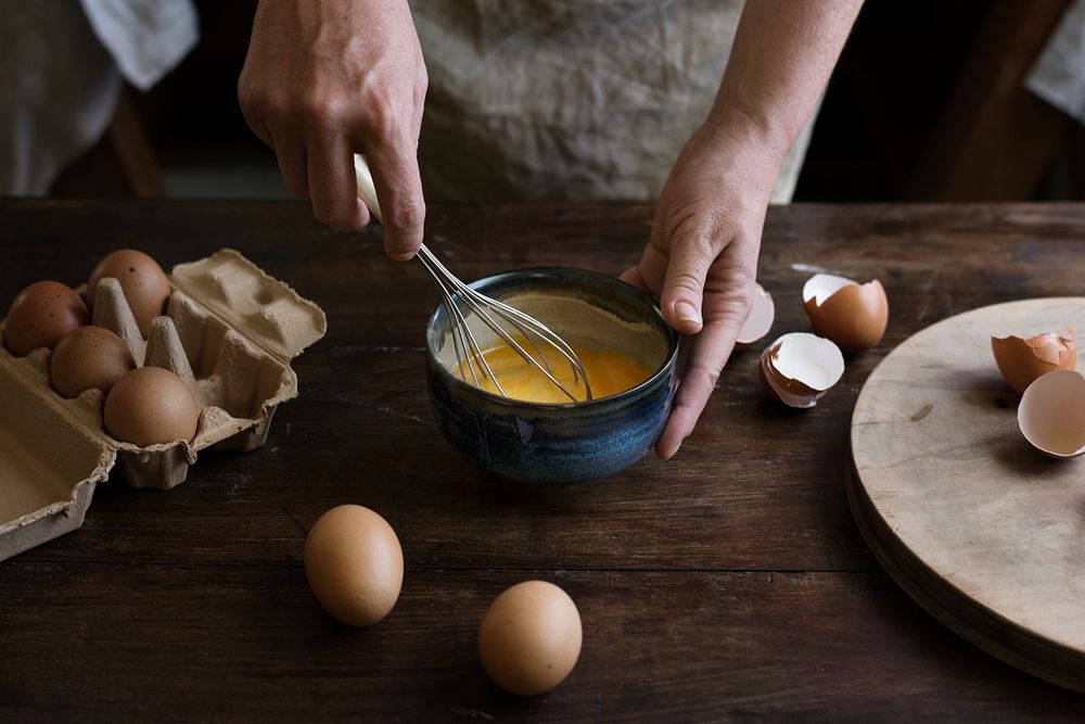 Woman beating eggs into a batter