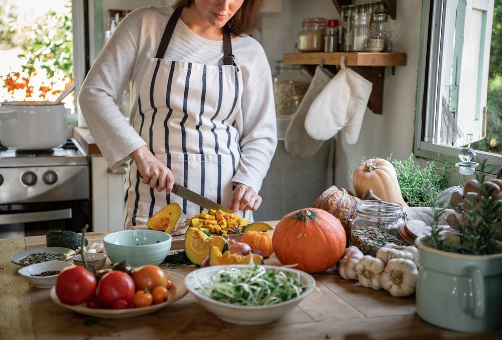 Woman chopping pumpkins in the kitchen