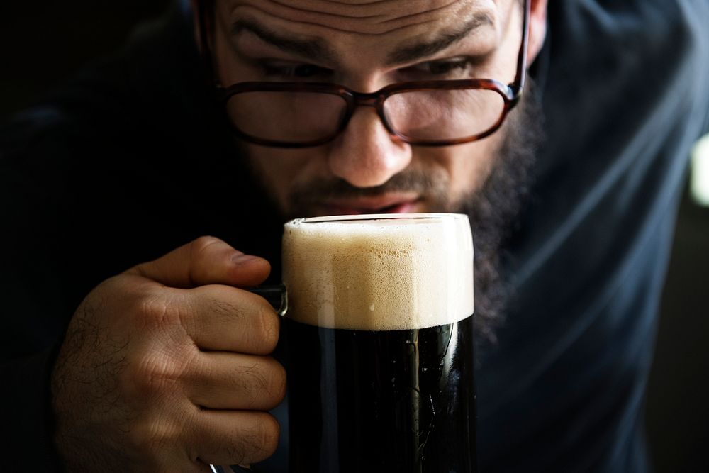 Man taking the first sip of a beer