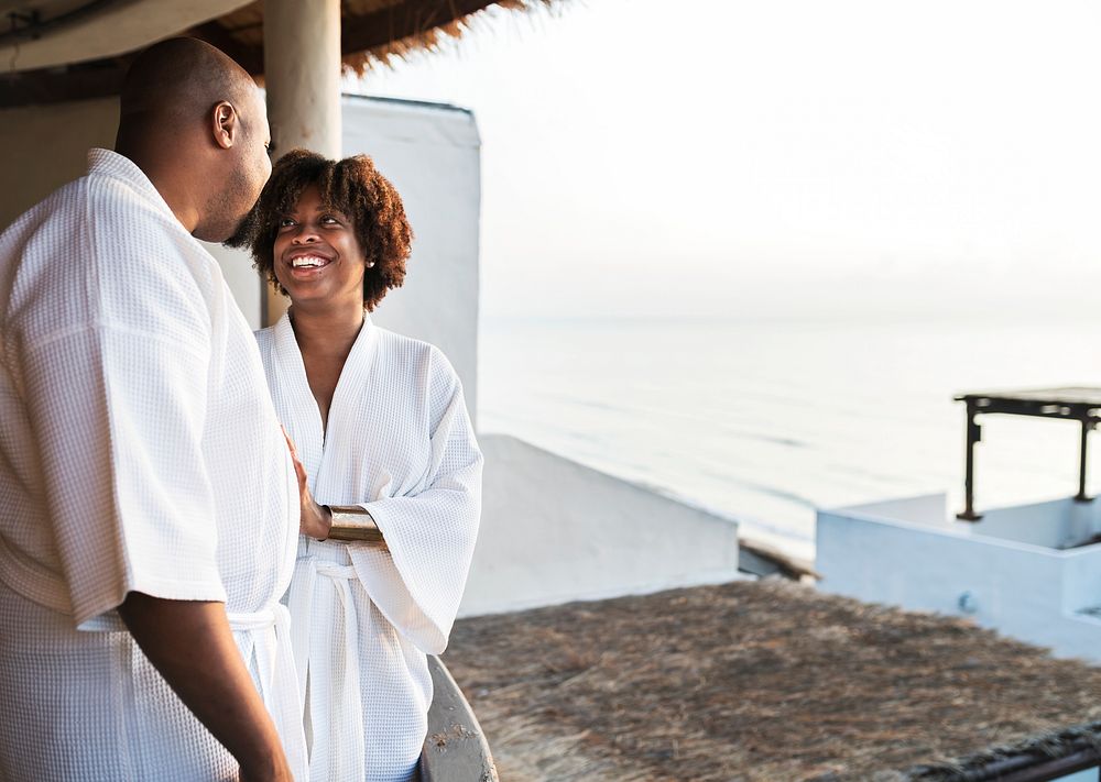African American couple in bathrobes at hotel