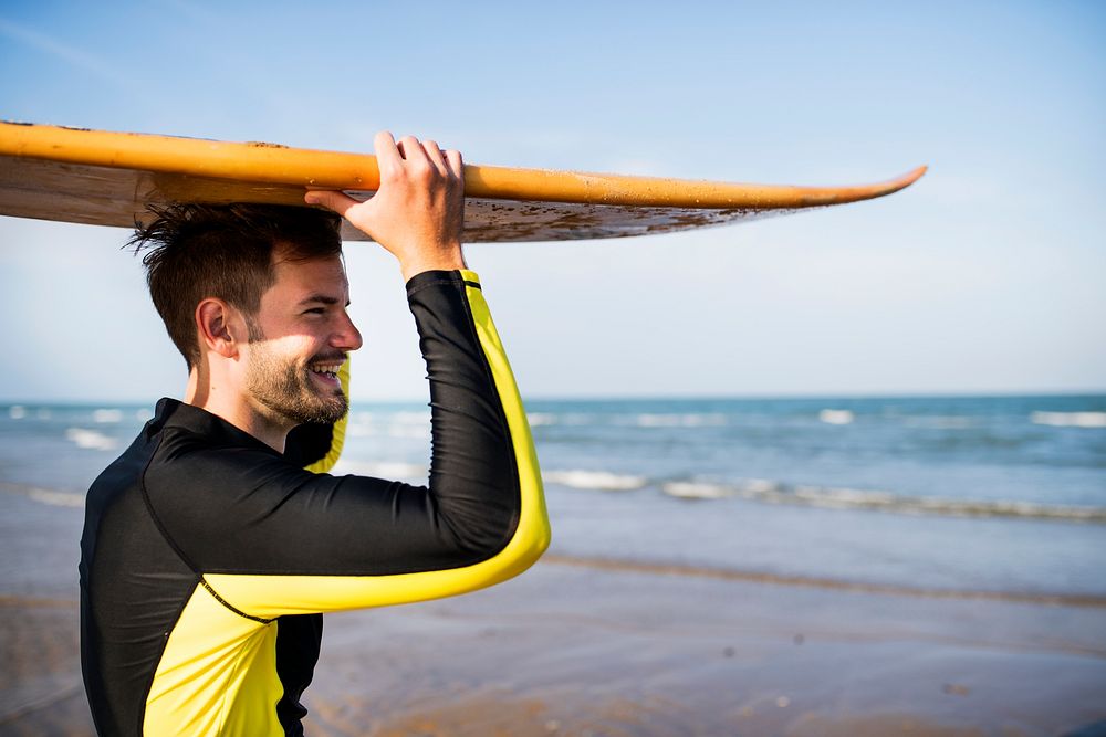 A man carrying a surfboard