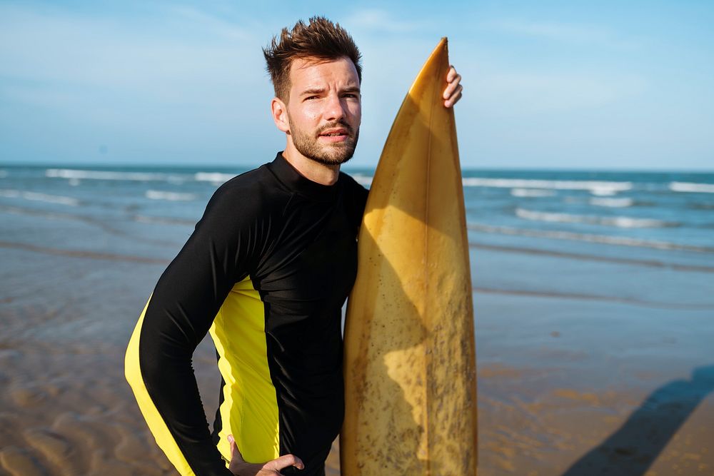 Man with a surfboard at the beach