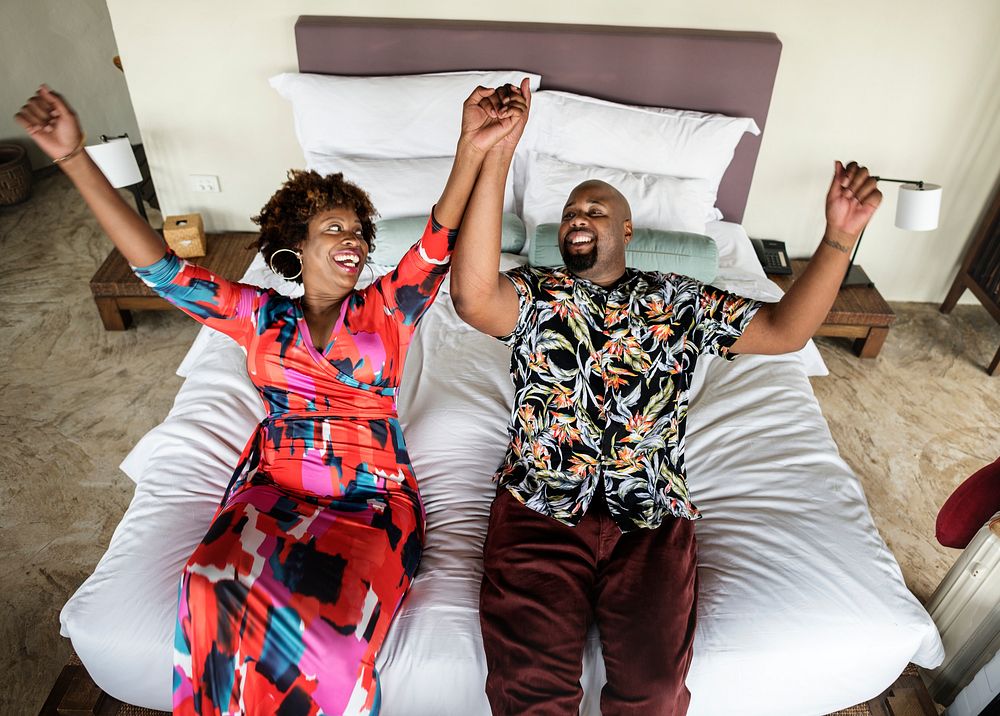 African American couple relaxing on a bed