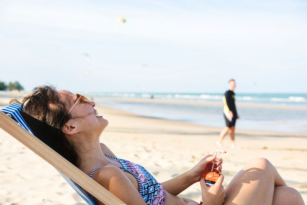 Couple relaxing with beers on the beach