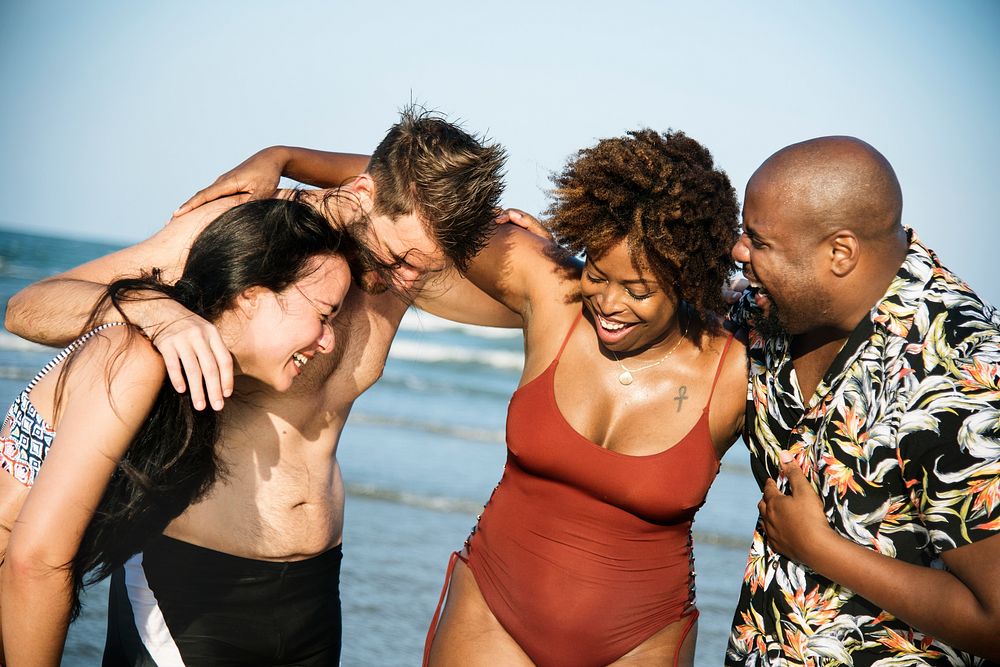 Group of cheerful friends at the beach