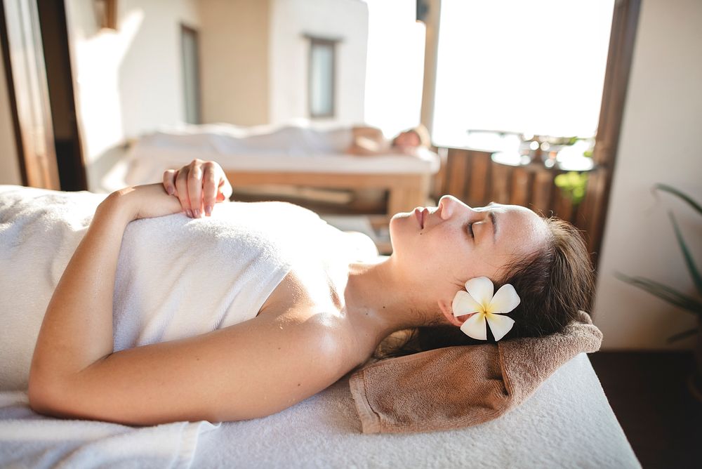 Caucasian woman relaxing with herbal massage