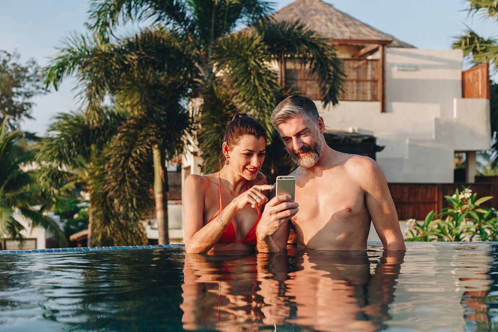 Honeymoon couple happy time in swimming pool