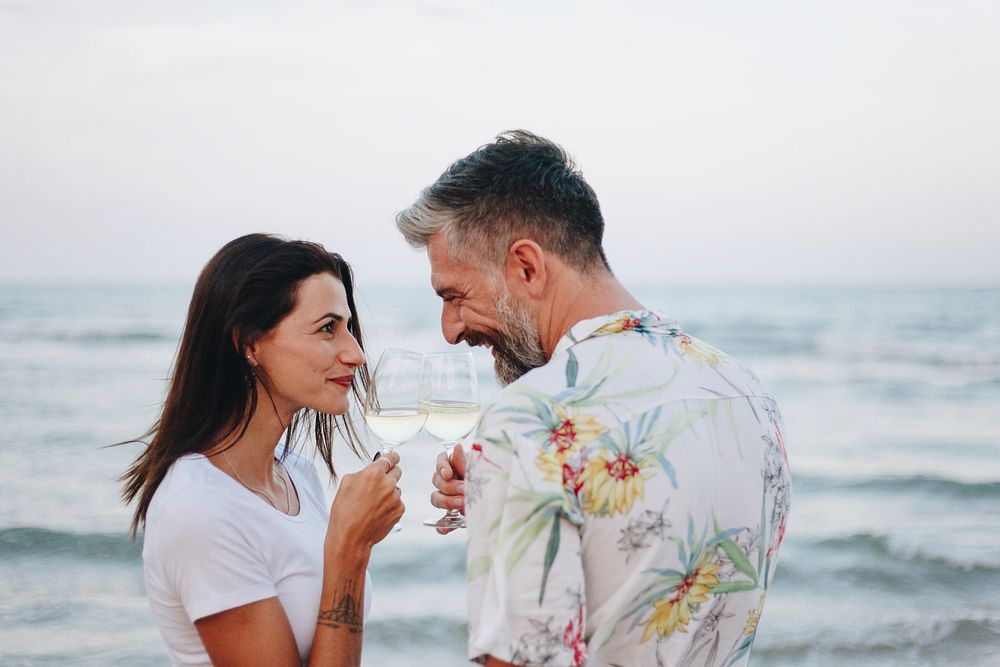 Couple enjoying a glass of wine by the beach