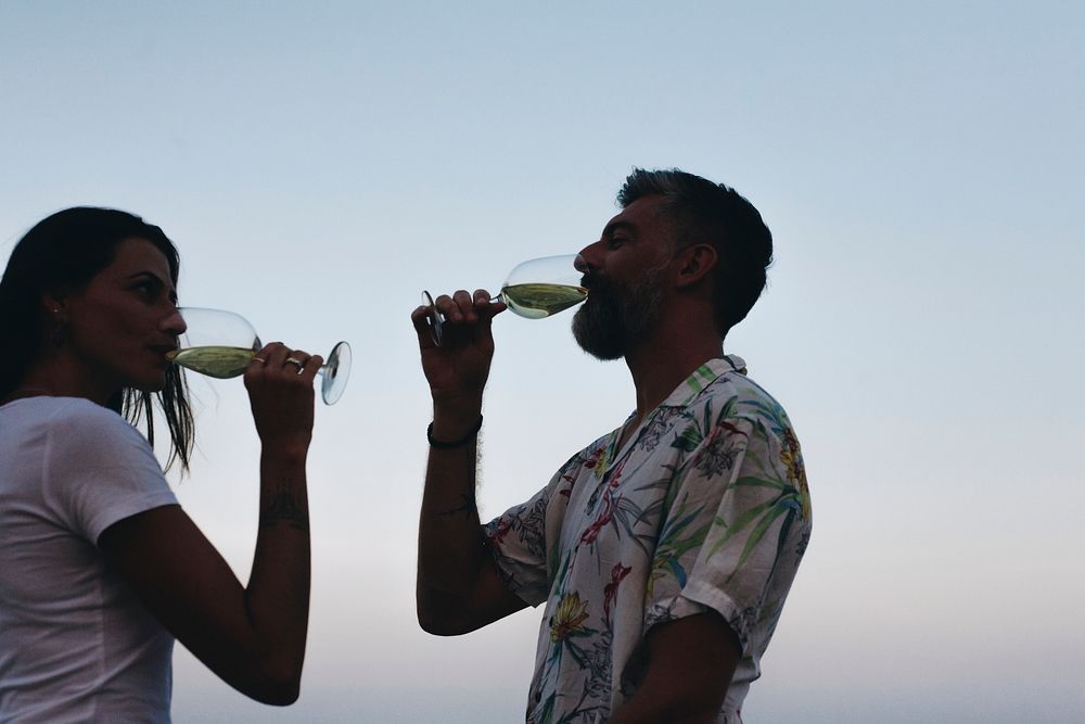 Couple enjoying a glass of wine by the beach