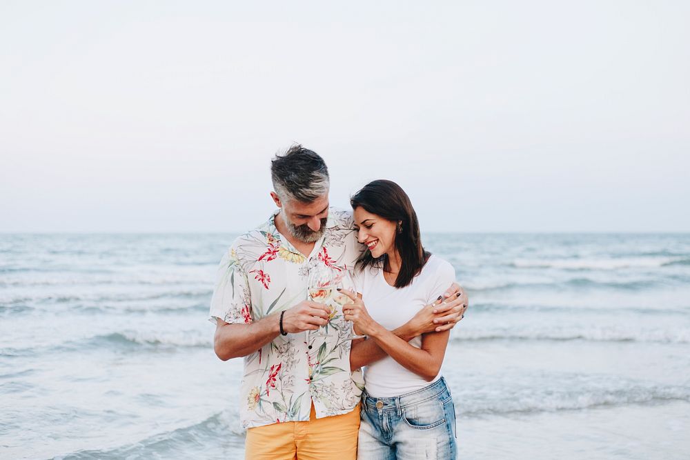 Couple enjoying a glass of wine by the beach