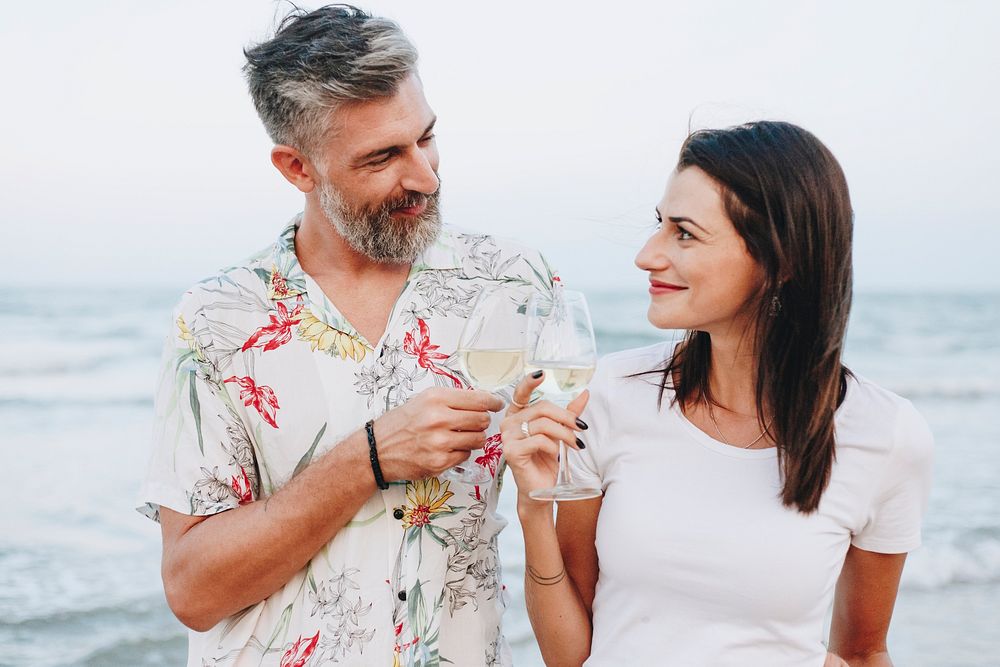 Couple enjoying a glass of wine by the beach