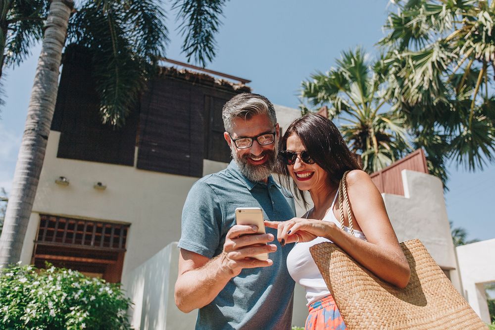 Couple using their phone while on vacation