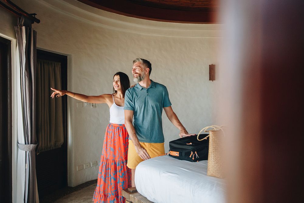 Honeymooners checking in to a hotel room