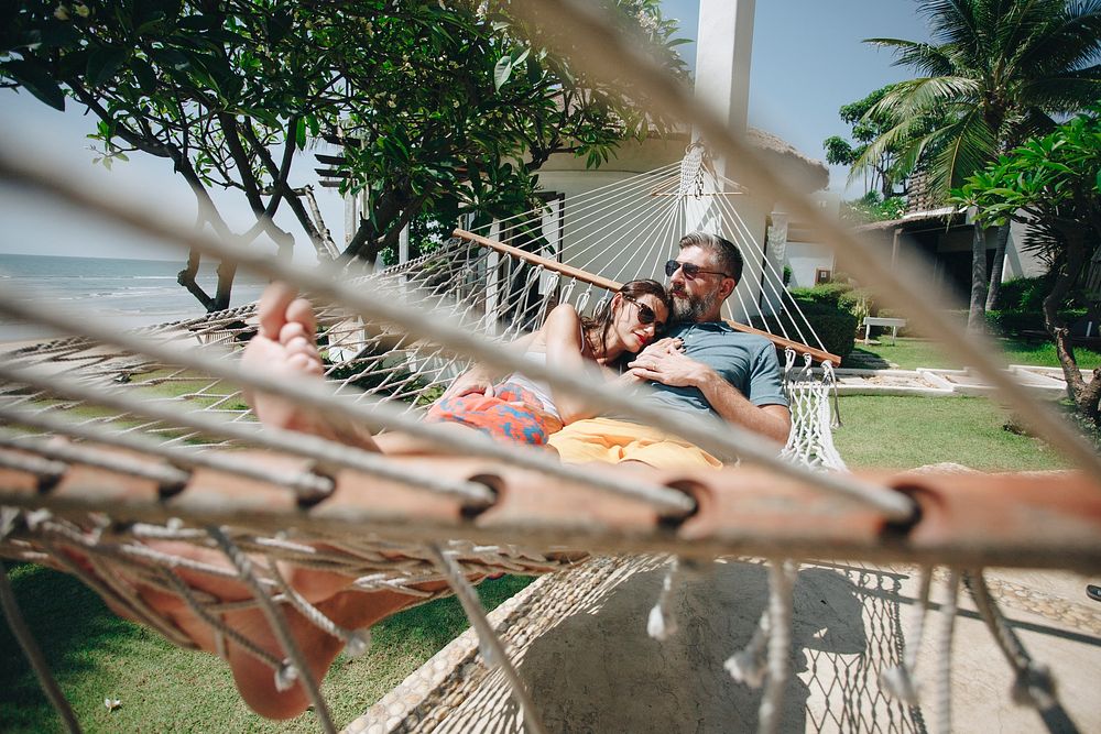 Couple relaxing in a hammock by the beach