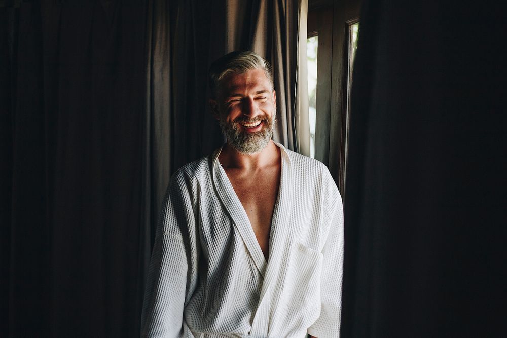 Cheerful man in a bathrobe