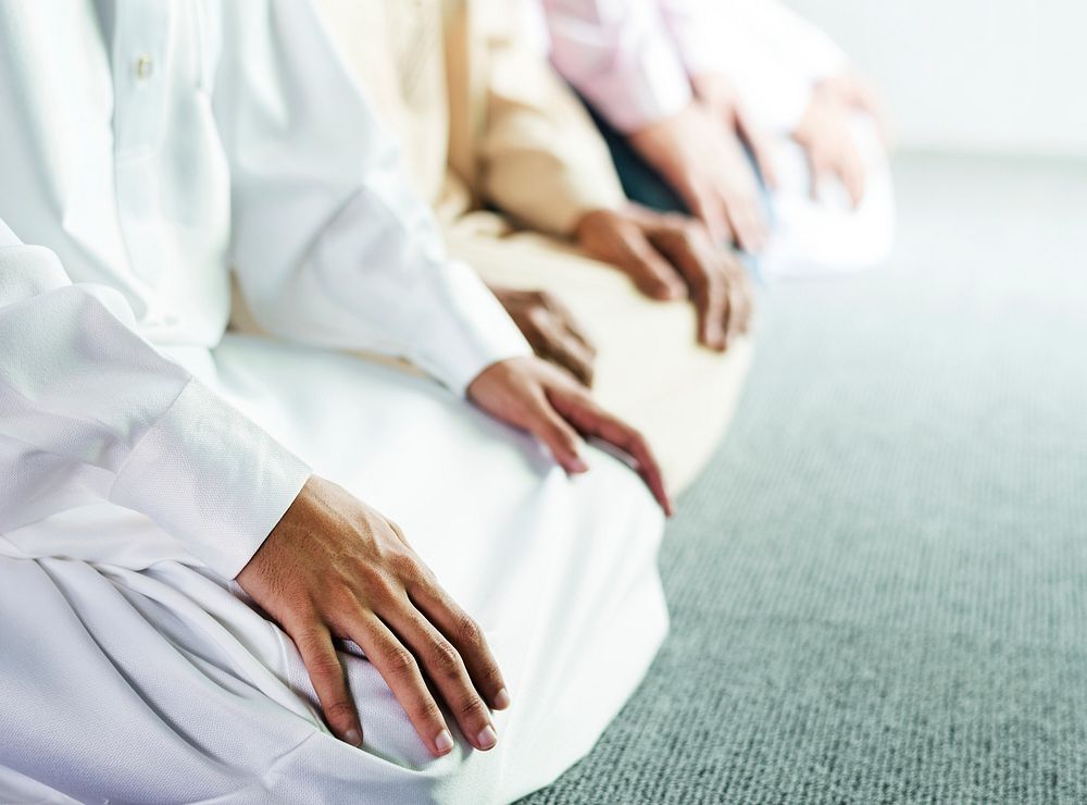 Muslim praying in Tashahhud posture