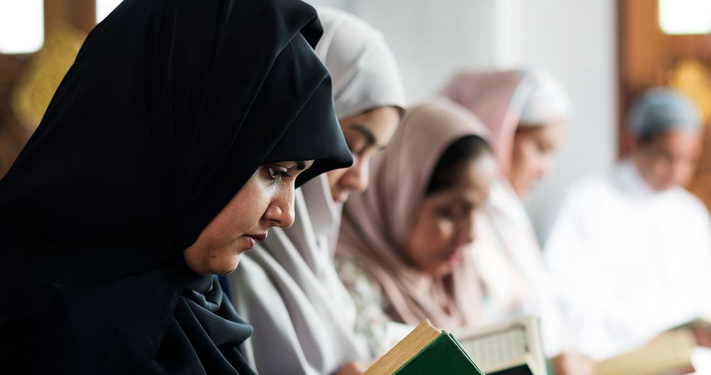 Muslim women reading Quran in the mosque during the Ramadan