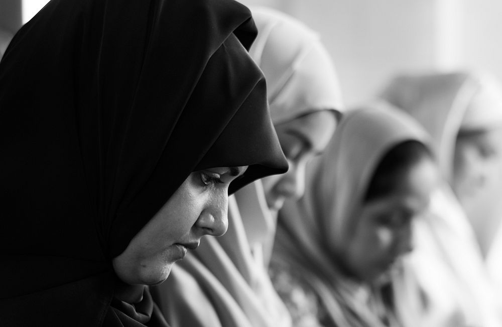 Muslim women praying in Tashahhud posture