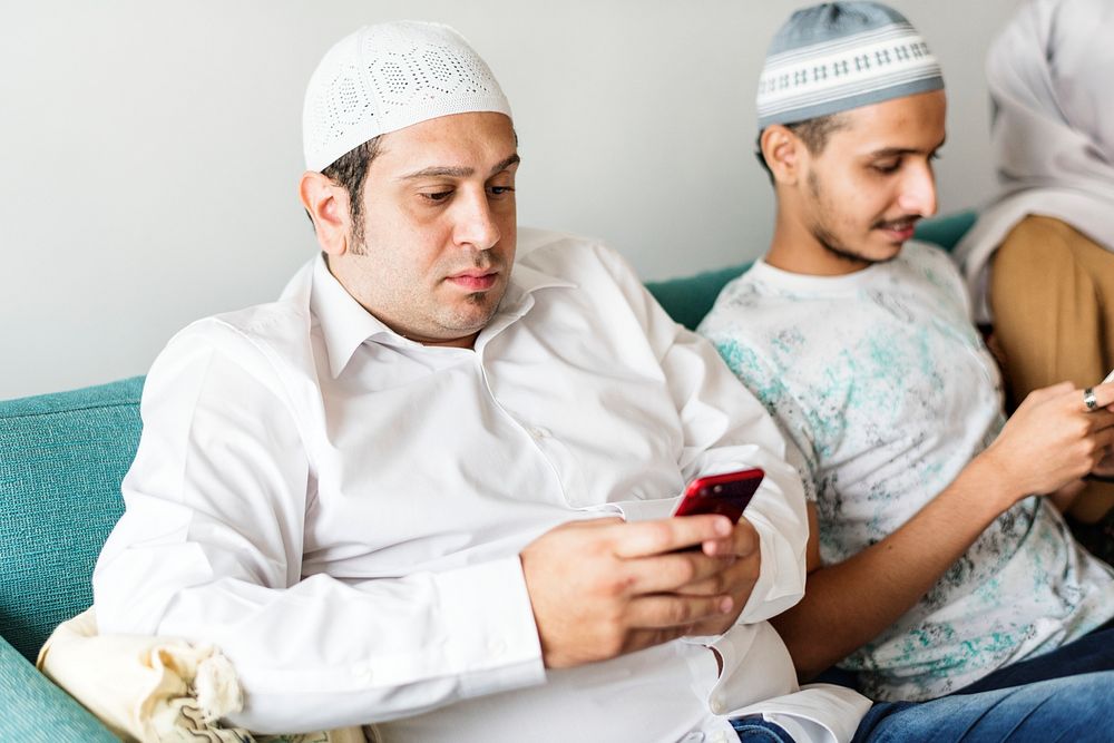 Muslim friends using social media on phones