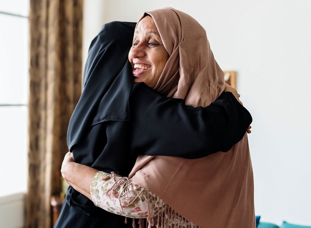 Muslim women hugging each other