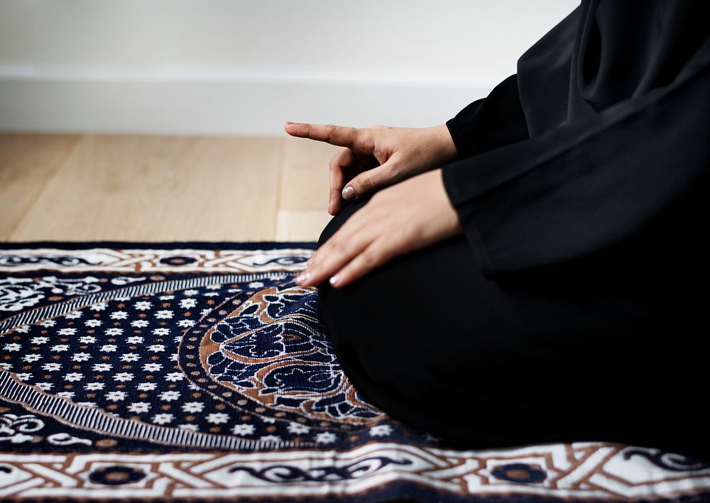 Muslim woman praying in Tashahhud posture