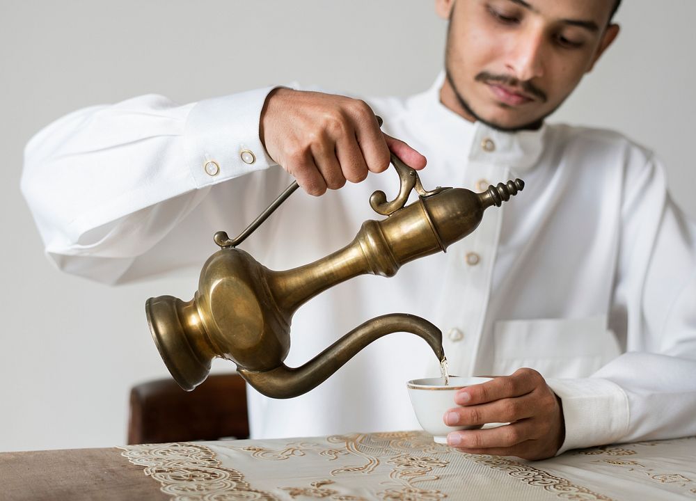 Muslim man having a cup of tea
