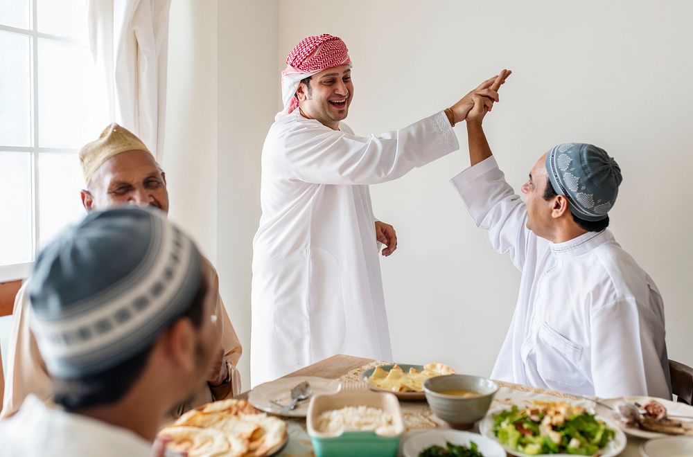 Muslim men making a high five
