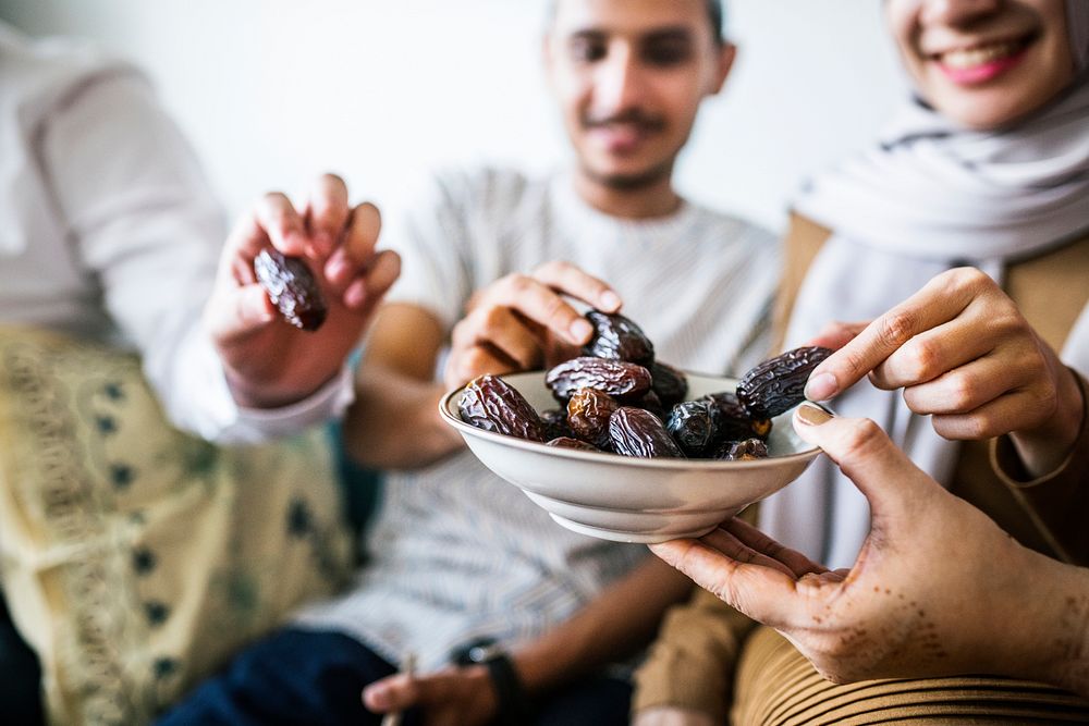 Muslim family having dried dates as a snack